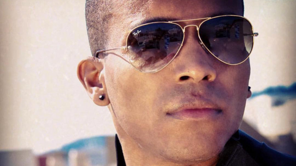 Olaf Blackwood wearing sunglasses with a blurred background